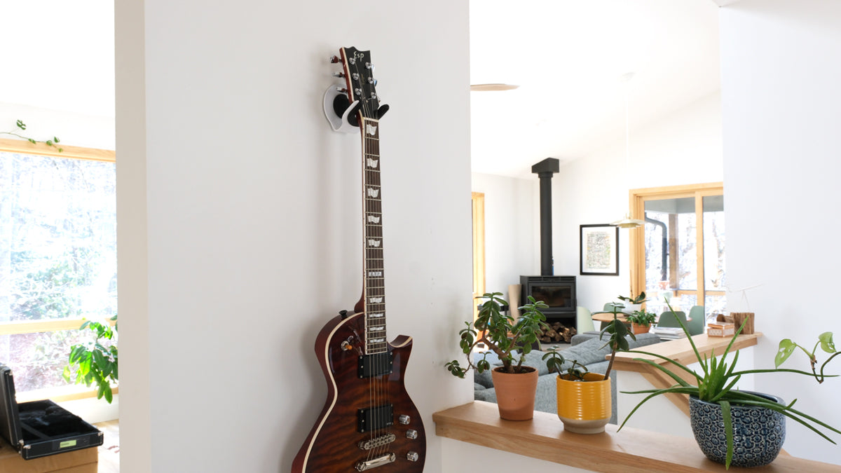 After testing cheap guitar hangers, I designed a modern solution